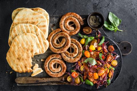 Sausage spirals with grilled bread and tomatoes