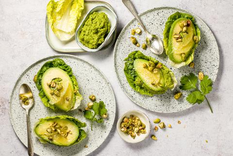 Pea hummus with pistachios and avocado on lettuce hearts 