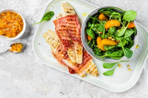 Grilled pangasius fillets with apricots and cured ham