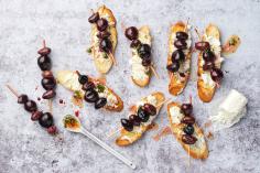 Crostini with cherry and olive skewers