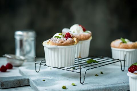 Raspberry and pistachio soufflé with yoghurt ice cream