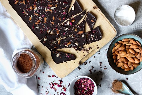 Homemade chocolate with almonds and edible flowers