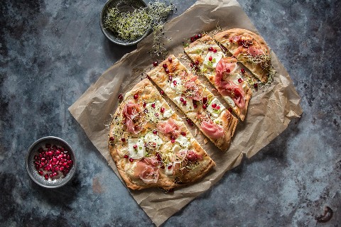 Tarte flambée with soft goat's cheese and cured ham