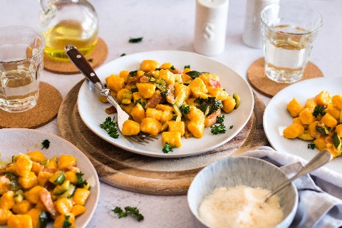 Carrot gnocchi with bacon and courgette