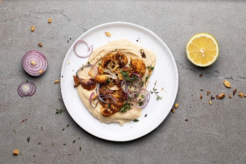 Cauliflower steak chunks with bean puree